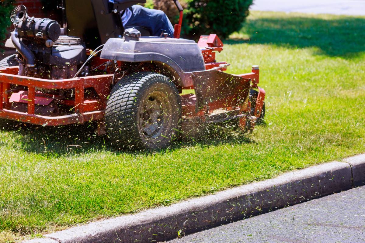 A landscape worker cutting grass on a riding lawnmower at Sharp Lawn near Lexington, KY